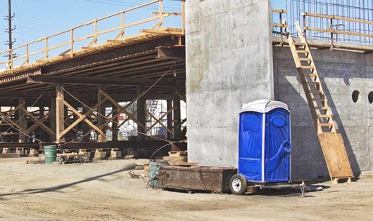 rows of portable restrooms at a construction site, providing essential amenities for workers